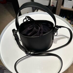 Black bucket Handbag with cross body strap.